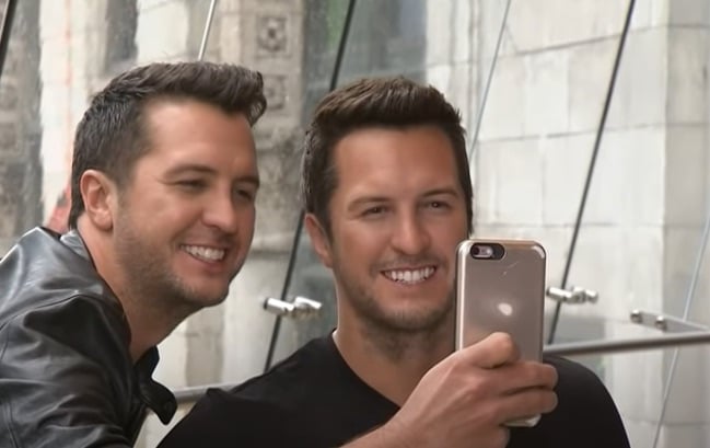 Luke Bryan poses with his wax figure at Madame Tussauds, where Randy Travis later surprised some fans