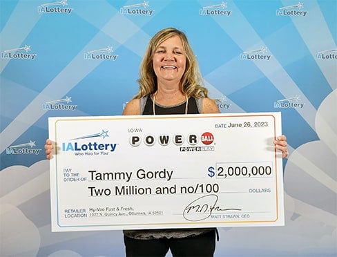 Tammy holding up the 2 million dollar lottery check. 