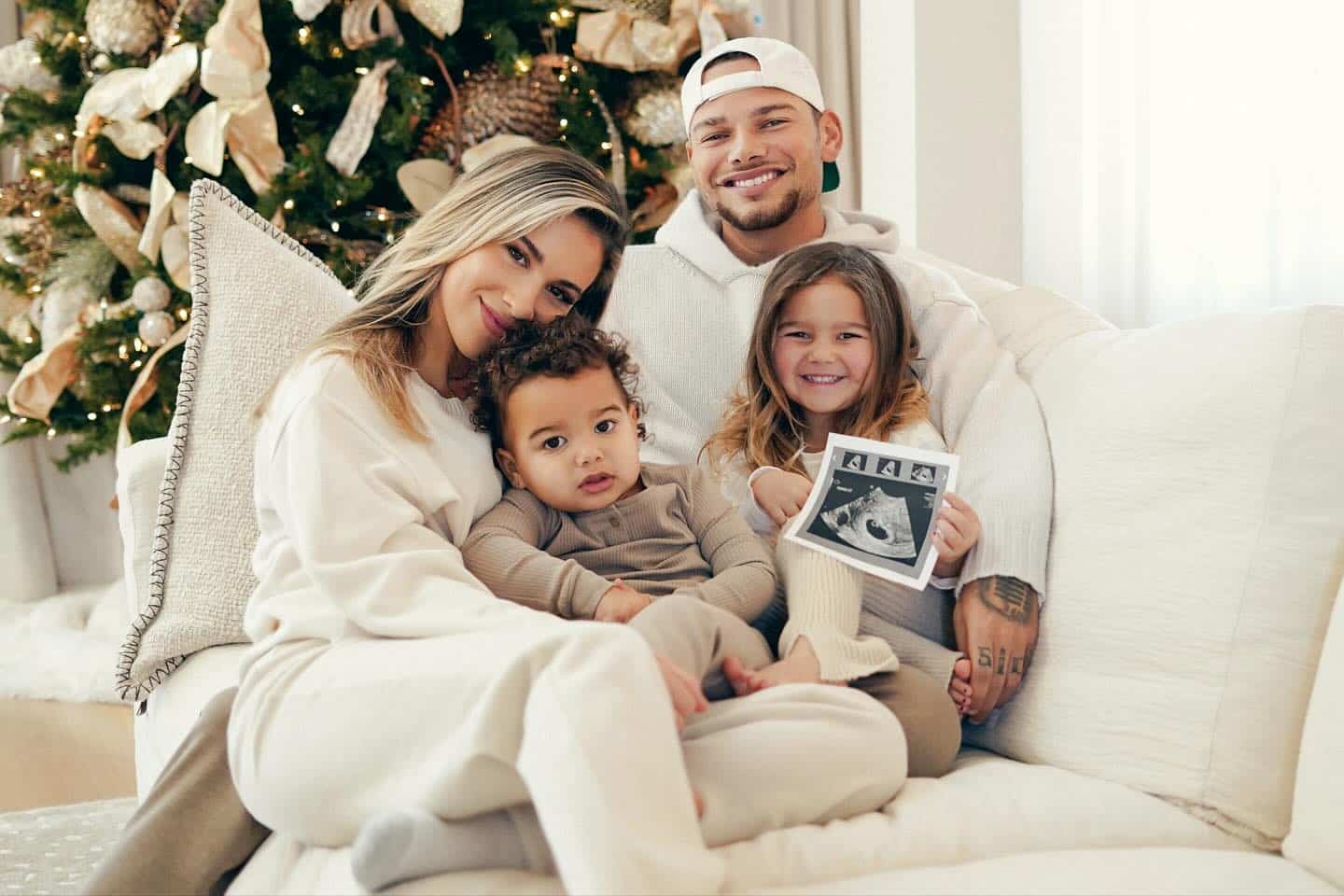 Kane and Katelyn Brown pose with their daughter, Kingsley, daughter Kodi, and a sonogram photo to announce they're expecting their third child.