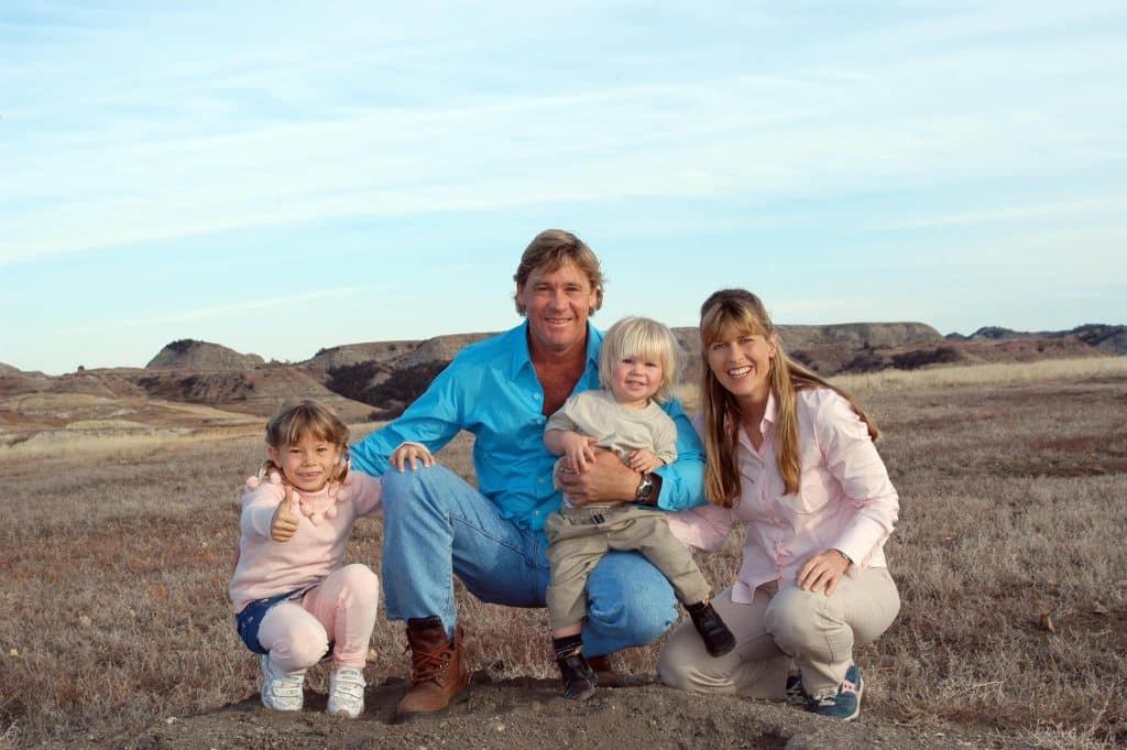 A young Robert is pictured with his sister, Bindi, mom Terri, and his late father Steve.