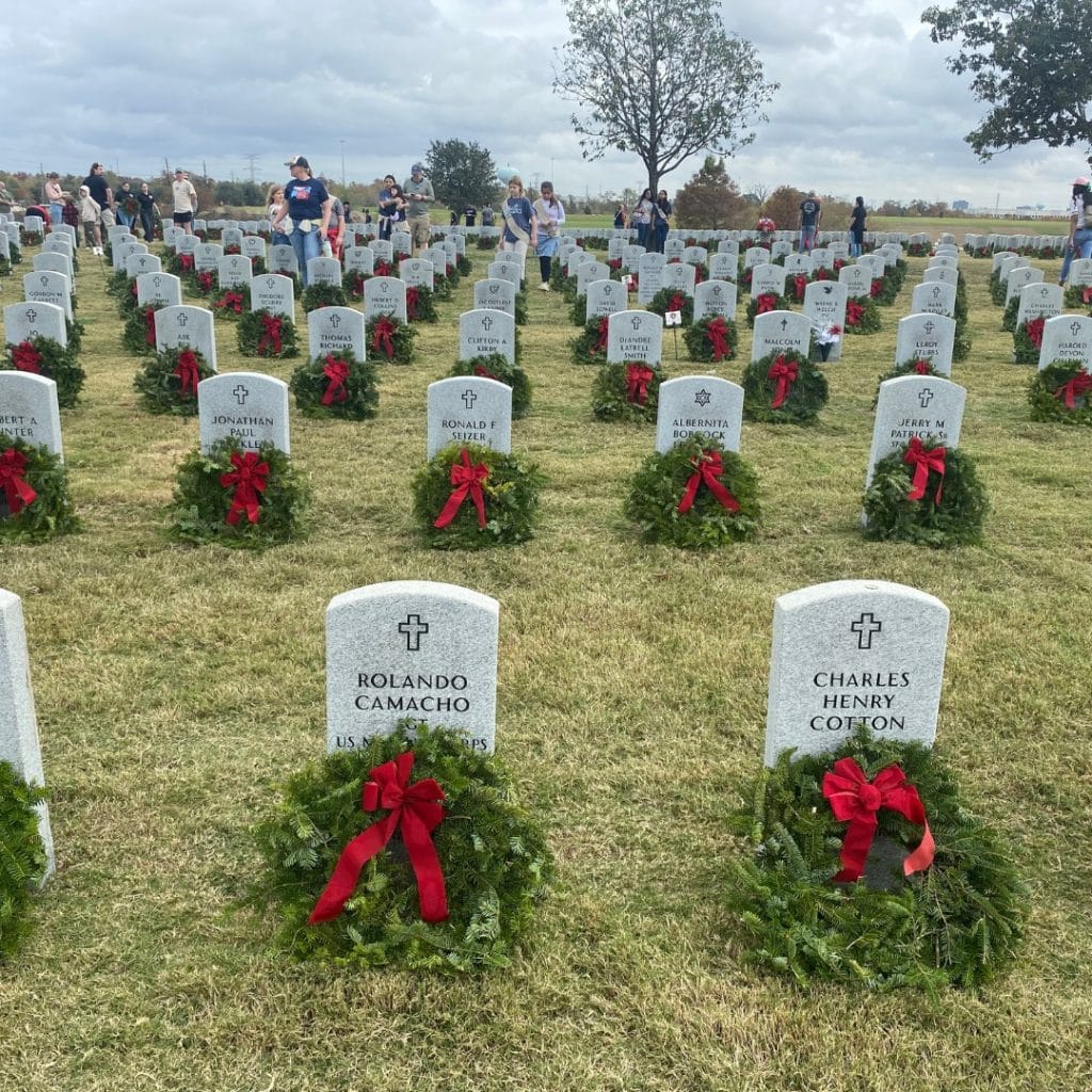 Christmas wreaths placed at the gravesites of fallen military members 