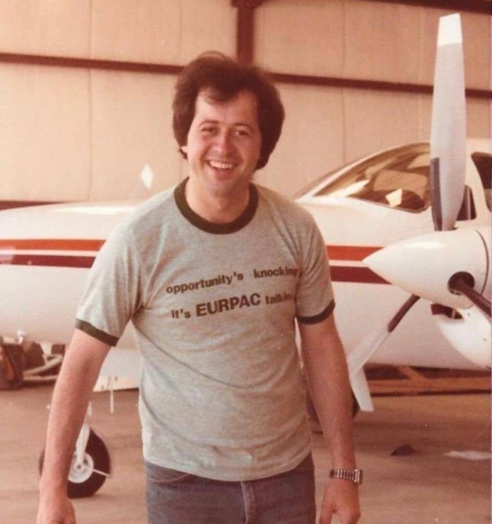 A young Wayne Osmond in front of an airplane 