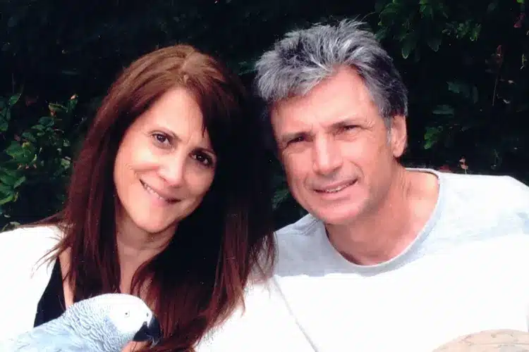Robin Kaye and her husband Thomas Deluca with a parrot
