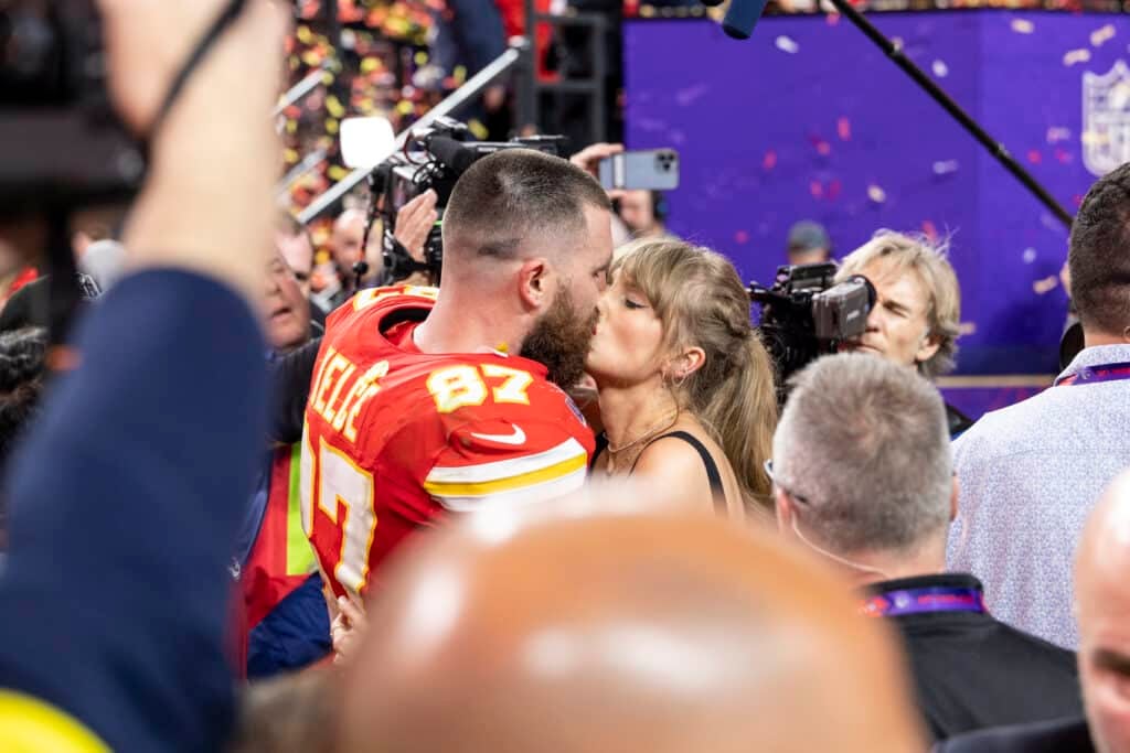 Taylor Swift and Travis Kelce kiss after the 2024 Super Bowl
