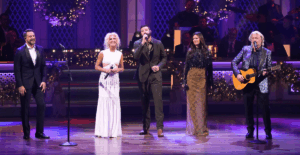 CMA Country Christmas host Jordan Davis performs with Little Big Town