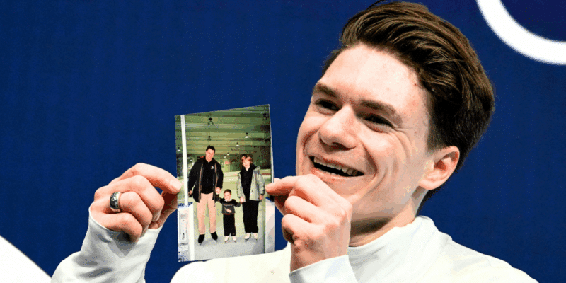 After qualifying to compete in the Men's Single Skating Short Program at the Milano Cortina Winter Olympic Games on Tuesday, Feb. 10, Maxim Naumov held up a photo of his late parents who died in the Potomac River collision on Jan. 29, 2025.